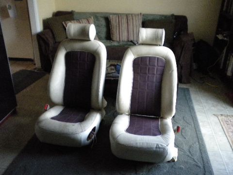1989 Ford Bronco - Two car seats with beige and purple upholstery are shown indoors.
