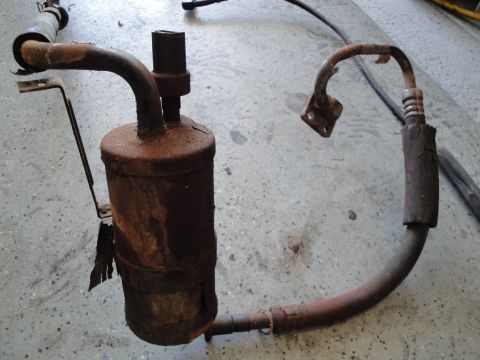 1989 Ford Taurus - This rusty air conditioning receiver-drier is a vehicle part, not a 1989 Ford Taurus.