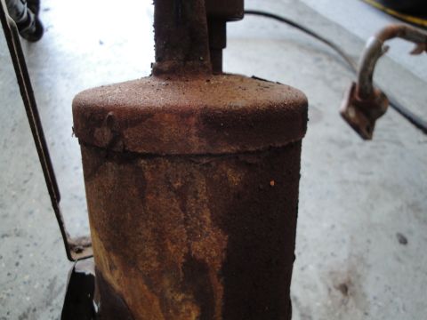 1989 Ford Taurus - This heavily rusted exhaust component shows significant signs of wear and tear.
