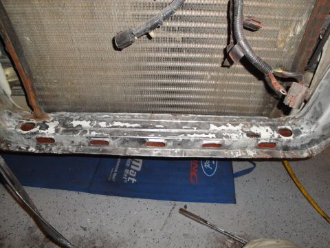1989 Ford Taurus - Radiator and mounting bracket assembly with visible wiring harnesses.