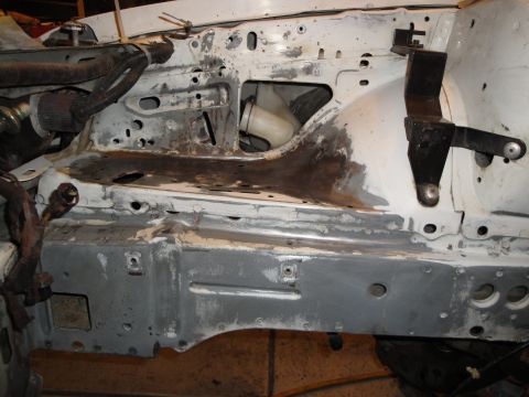 1989 Ford Taurus - The engine bay structure of a vehicle is shown, with visible metalwork and some components.