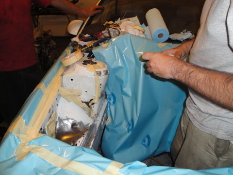 1989 Ford Taurus - Work in progress on a car's engine bay, covered for protection during repairs or modifications.