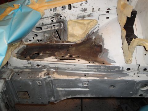 1989 Ford Taurus - Chassis section shows rust and is prepped for work, with masking tape applied.