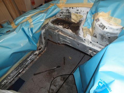 1989 Ford Taurus - The interior of a vehicle is being prepped for work, with protective coverings and tools visible.
