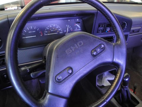 1989 Ford Taurus - The 'SHO' emblem on the steering wheel indicates this is likely a performance variant, but the year and model are not definitively identifi…