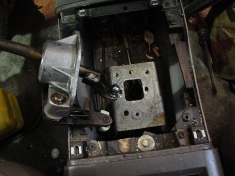 1989 Ford Taurus - The internal components of a car's center console shifter are visible after disassembly.