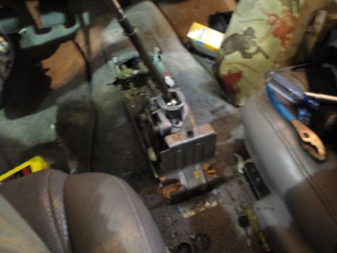 1989 Ford Taurus - Car interior showing a disassembled center console and shift mechanism, with tools nearby.
