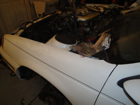1989 Ford Taurus - Engine removal in progress on a 1989 Ford Taurus.