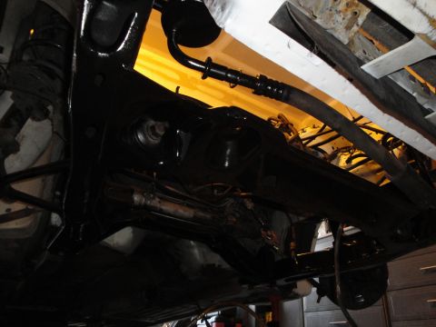 1989 Ford Taurus - Close-up of the undercarriage, showing suspension and frame work.