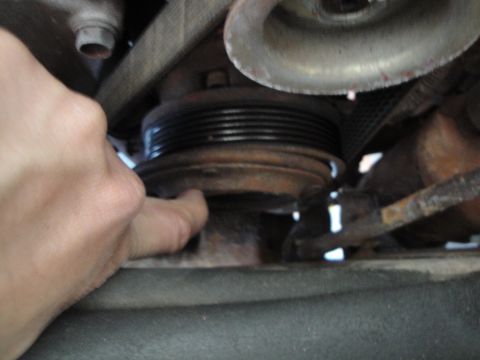 1989 Ford Taurus - Close-up of an engine pulley and belt system.