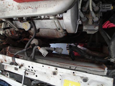 1989 Ford Taurus - Close-up view of an engine bay, showing the valve cover and associated wiring.