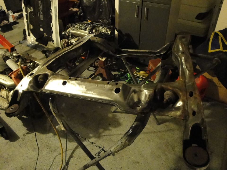 Bare metal subframe on stand in garage