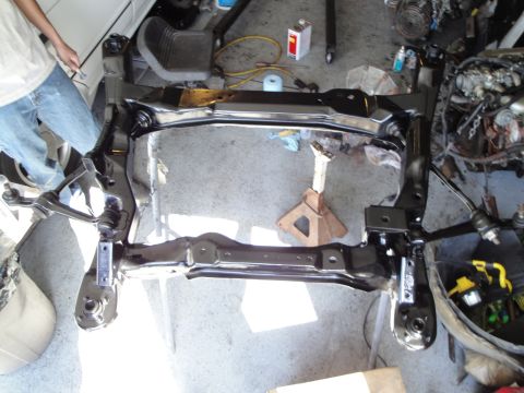 1989 Ford Taurus - Front subframe assembly with suspension components, likely undergoing restoration or repair.