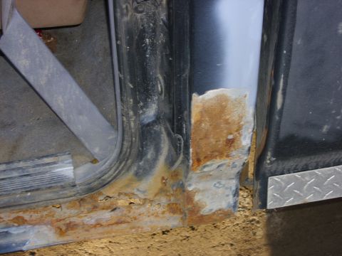 1995 Ford F-150 - Significant rust damage is visible on the door sill and rocker panel of this vehicle, indicating potential structural issues.