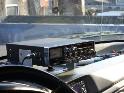 1995 Ford F-150 - Uniden DX99V CB radio unit with analog meter and multiple knobs on a vehicle dashboard.