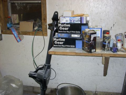 1995 Ford F-150 - Boxes of automotive parts are stacked on a shelf next to a differential housing.