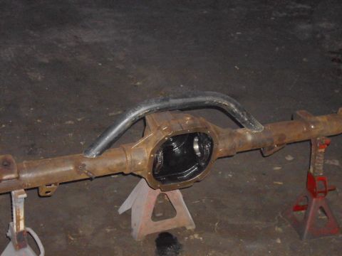 1995 Ford F-150 - A rusty Ford rear axle assembly is shown on jack stands, ready for modification or installation.