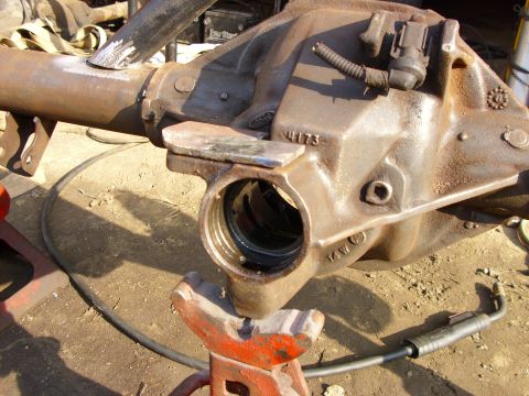 1995 Ford F-150 - A rusty differential housing is supported by an orange jack stand, with a welding torch nearby.