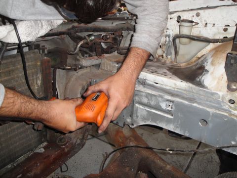 1989 Ford Taurus - Working on the engine bay of a vehicle, possibly during a repair or modification.