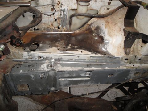 1989 Ford Taurus - The engine bay of a vehicle shows significant rust and exposed metal, indicating a need for repair or modification.