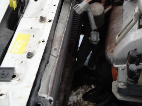 1989 Ford Taurus - Engine bay components including radiator, hoses, and electrical connectors are visible.