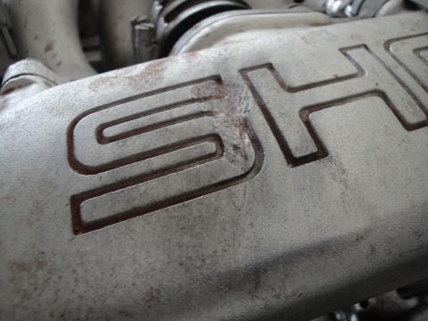 1989 Ford Taurus - This close-up shows the embossed letters 'SHO' on an engine component, likely from a performance variant.