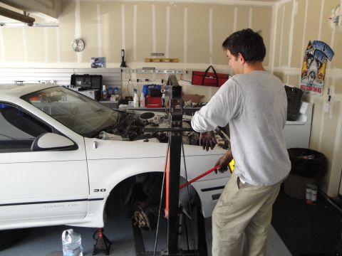 1989 Ford Taurus - Engine removal in progress on a 1989 Ford Taurus.