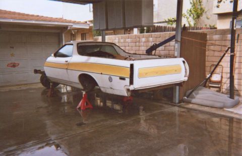 1972 Ford Ranchero - This 1972 Ford Ranchero is elevated on jack stands, showing its rear end with a distinctive yellow stripe along the side.