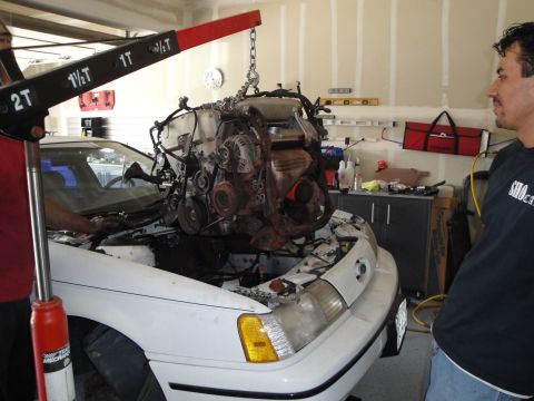 1989 Ford Taurus - Engine being hoisted out of a 1989 Ford Taurus during a swap.