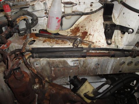 1989 Ford Taurus - Tools and engine components are visible in this engine bay photo.