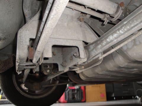 1989 Ford Taurus - This image shows the underside of a vehicle, focusing on the rear suspension components and the fuel tank.