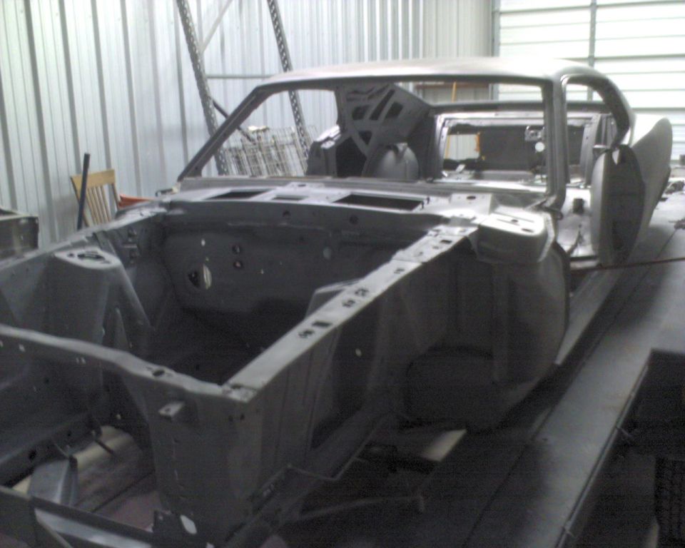 1970 Ford Mustang body shell, bare metal, in a workshop, 3q-front view