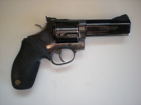 1974 Ford Ranchero - A black Taurus revolver is shown against a white background.