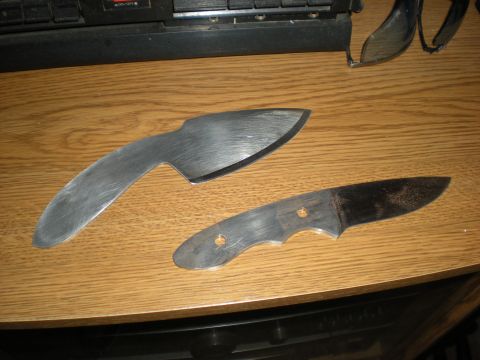 1974 Ford Ranchero - Two unfinished knife blades, one with a curved edge and the other with a pointed tip, lie on a wooden table.