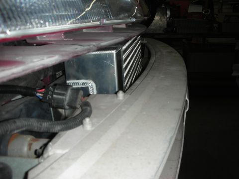 1992 Ford Crown Victoria - An intercooler unit is installed in the front of a vehicle, with wiring and part of the bumper visible.