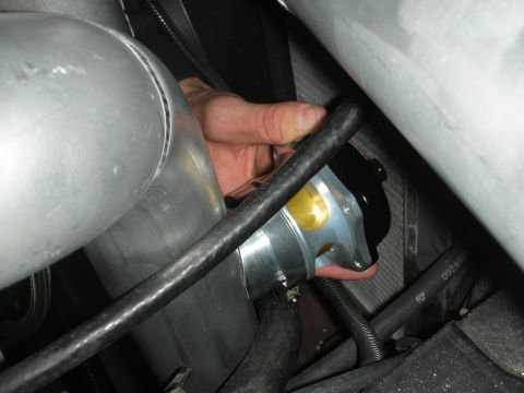 1992 Ford Crown Victoria - A hand is shown installing or adjusting a silver and gold blow-off valve attached to a large diameter aluminum pipe. Black hoses and wiring…