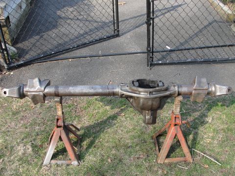 1995 Ford Bronco - Front axle assembly resting on jack stands, ready for installation or modification.