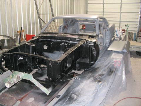 1970 Ford Mustang - A 1970 Ford Mustang body shell is prepared for restoration in a workshop environment.