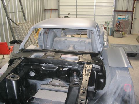 1970 Ford Mustang - The body of a 1970 Ford Mustang is shown in primer, ready for further restoration work in a garage setting.
