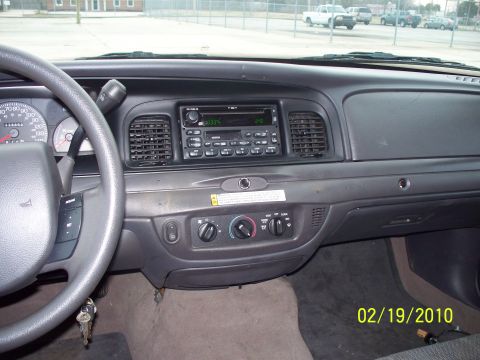2005 Ford Crown Victoria - Interior view of a car's dashboard, showing the steering wheel, radio, and climate controls, with a date stamp of 02/19/2010.