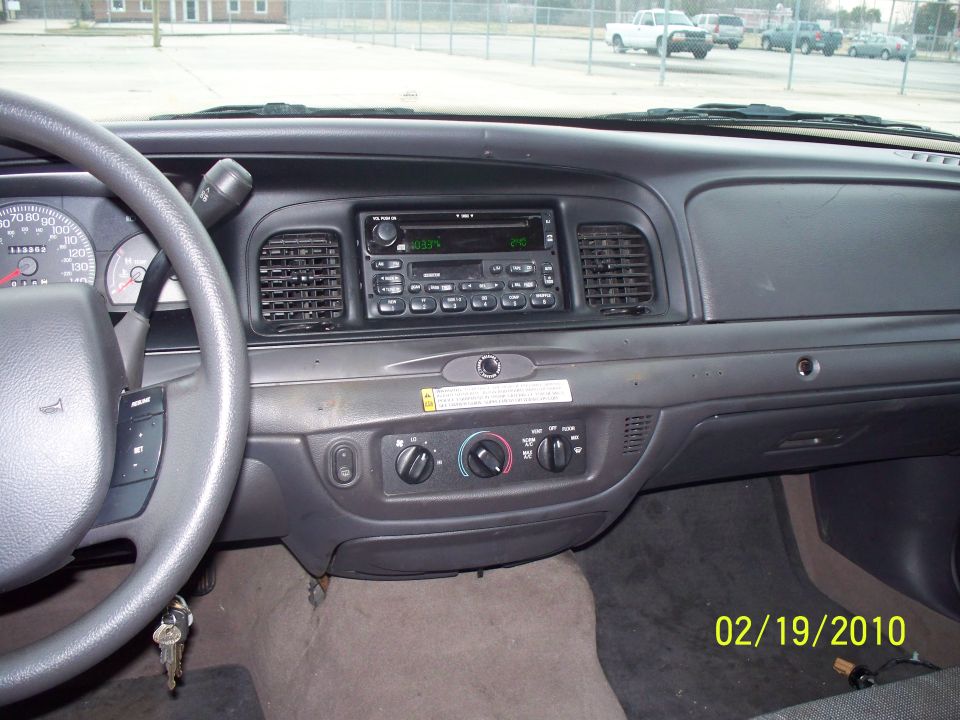 Car dashboard with steering wheel, radio, and climate controls. Date stamp reads 02/19/2010