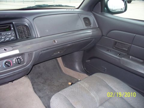 2005 Ford Crown Victoria - Interior view of a car's dashboard and passenger seat, with a visible date stamp.