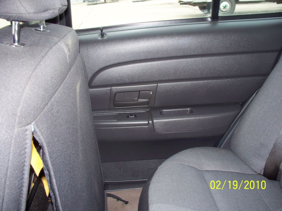 Rear door panel and seats of a dark-colored vehicle with a date stamp of 02/19/2010