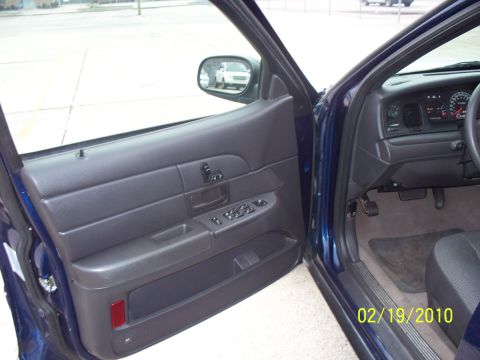 2005 Ford Crown Victoria - Interior view of a car, showing the driver's side door panel and dashboard with a date stamp.