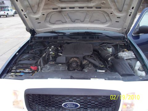 2005 Ford Crown Victoria - The engine bay of a 2005 Ford Crown Victoria is visible with the hood raised, showing the engine and various components. A date stamp indic…