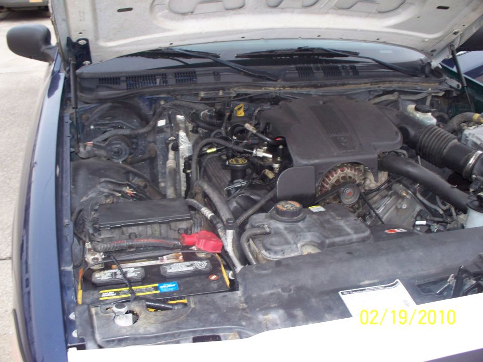 2005 Ford Crown Victoria engine bay with battery visible