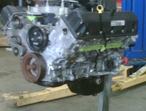 2005 Ford Crown Victoria - Engine assembly on a stand, with visible pulleys and valve covers.