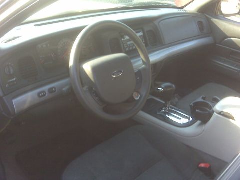 2005 Ford Crown Victoria - The interior of a 2005 Ford Crown Victoria, the dashboard, steering wheel, and center console.