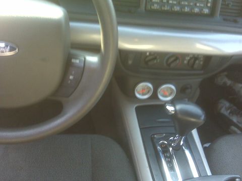 2005 Ford Crown Victoria - Interior view of a 2005 Ford Crown Victoria, highlighting the dashboard, steering wheel, and center console with gauges.