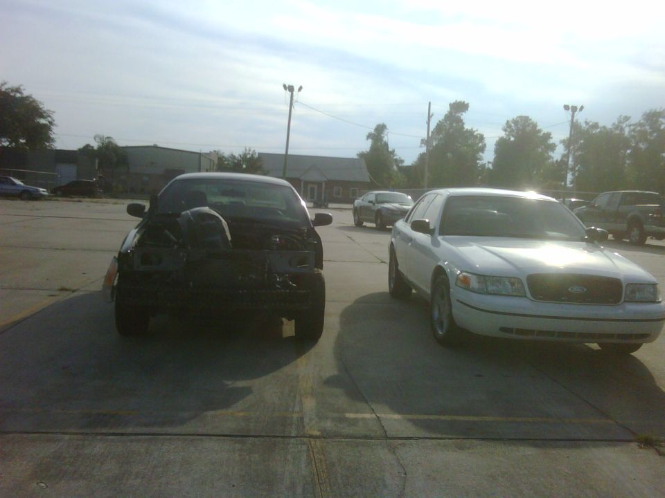 2005 Ford Crown Victoria parked next to another damaged Ford Crown Victoria